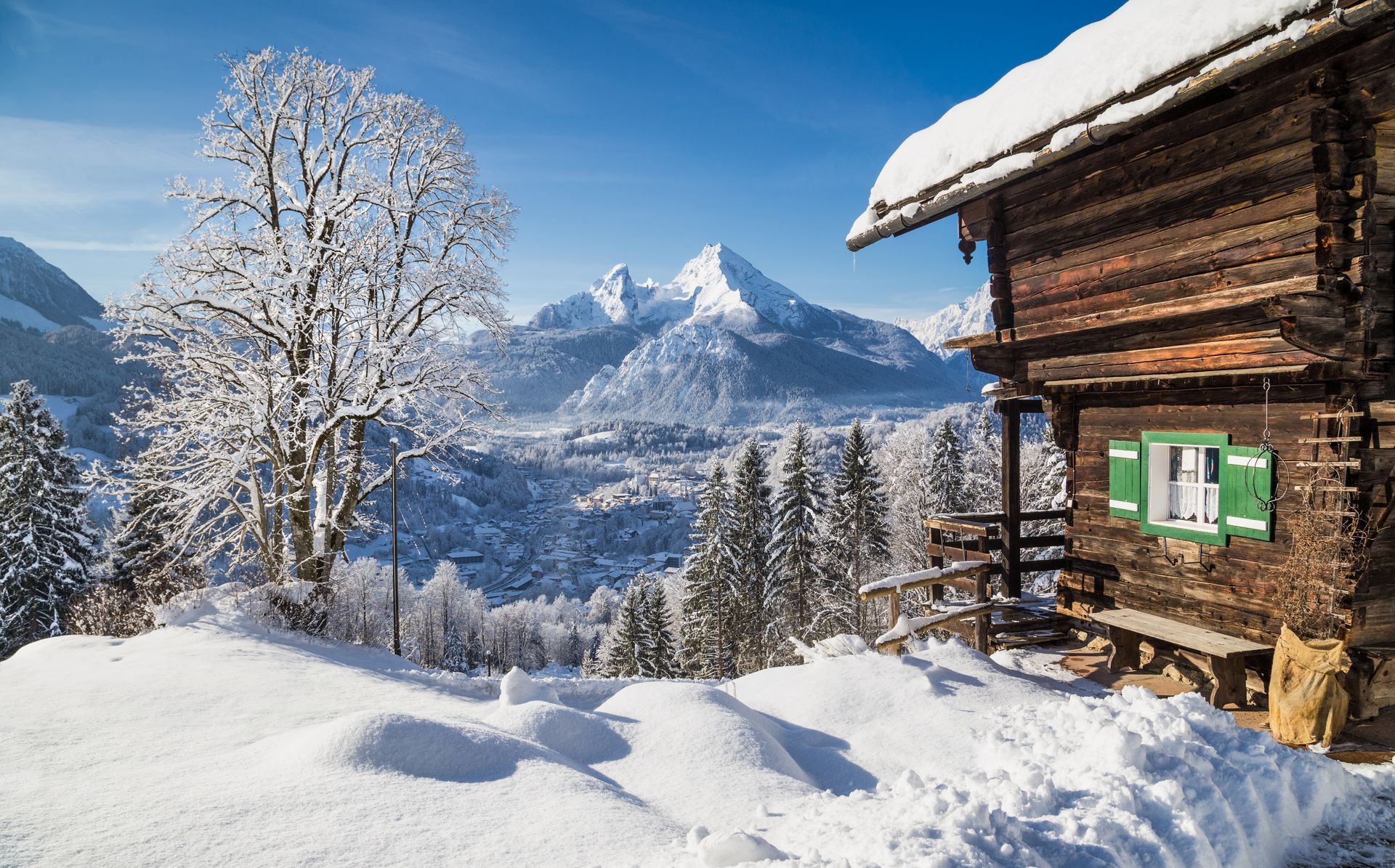 Winter wonderland in the Alps with traditional mountain chalet
