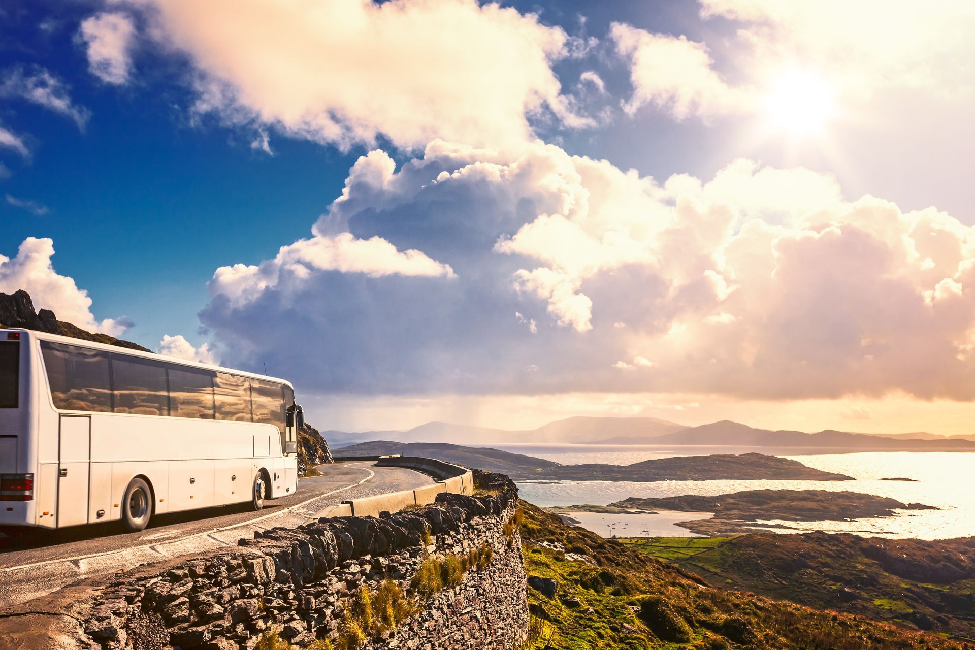 Tourist bus traveling on mountain road. Ring of Kerry, Ireland. Travel destination

